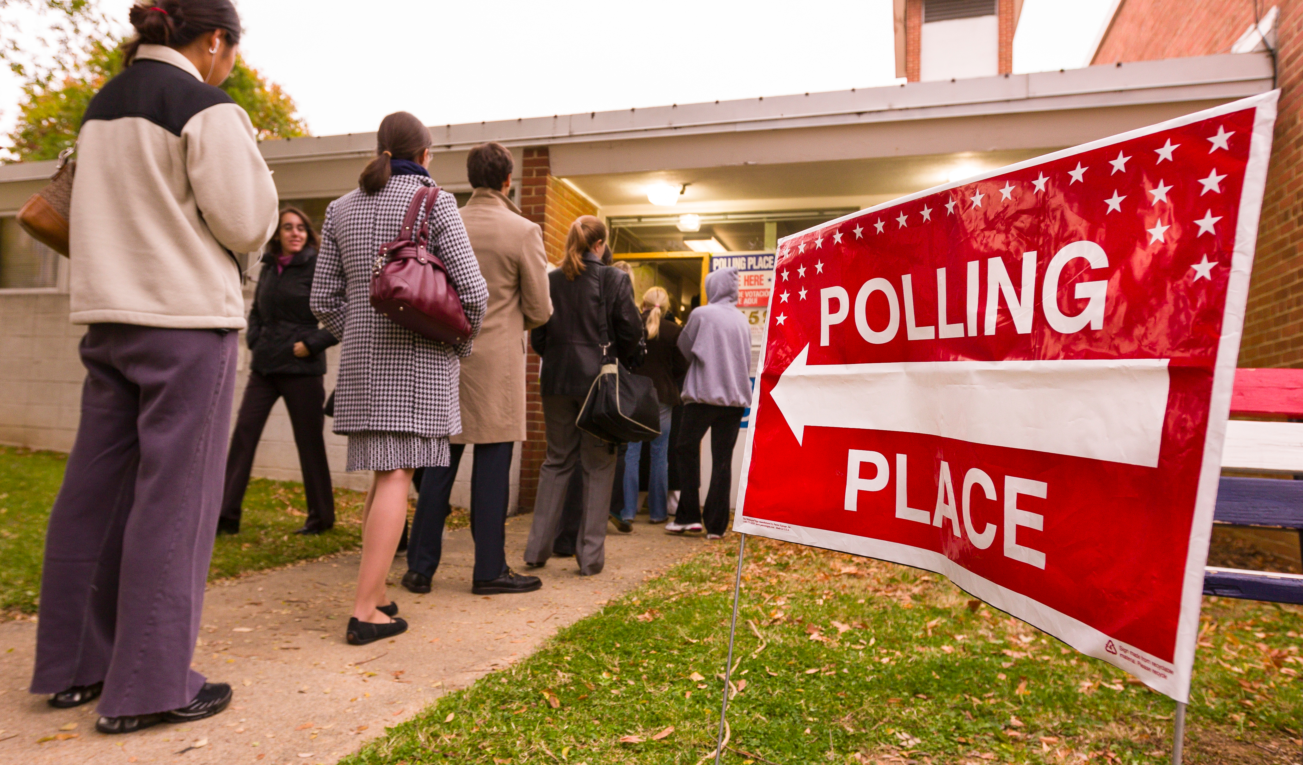 People lined up waiting to enter their polling place.